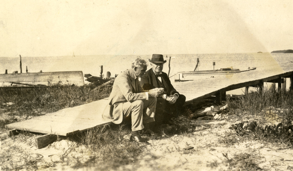 Henry Ford (left) and Thomas Edison (right) sitting on a pier at Punta Rassa (1925).