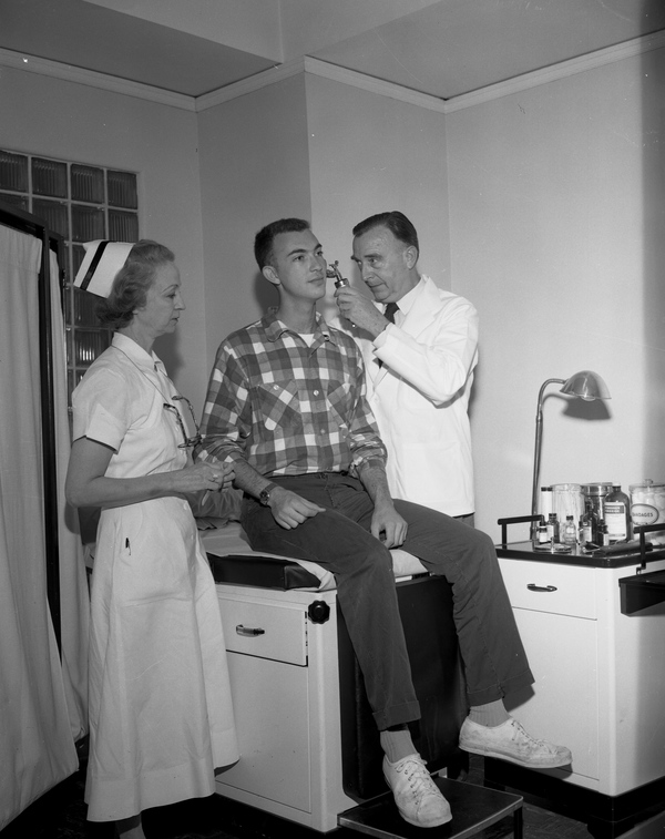 Doctor and nurse examining a patient at the FSU infirmary in Tallahassee (1959).