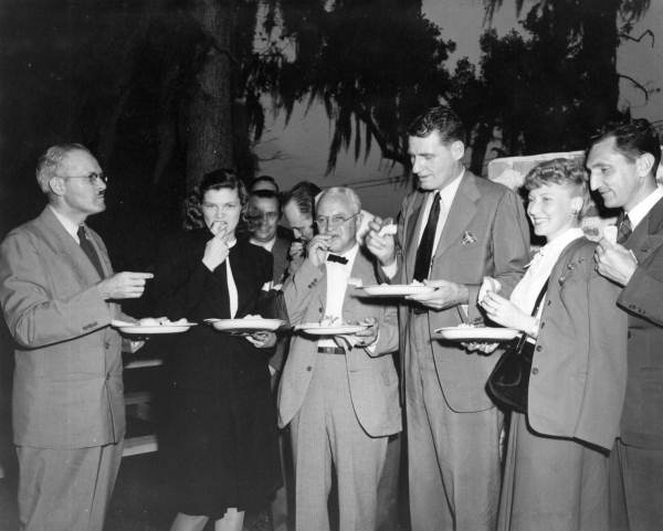 Barbara Frye enjoying eating at Governor Millard Caldwell's press conference in Orlando, 1946.