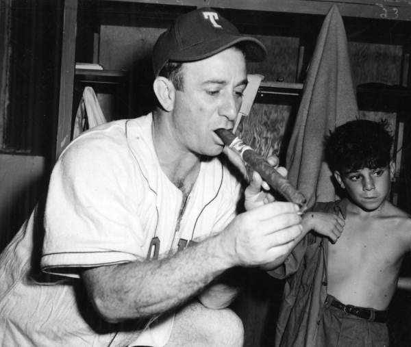 There's no question about the close relationship between the Tampa Smokers and the city's cigar industry. Here, Smokers manager Tony Cuccinello lights up (September 28, 1947).