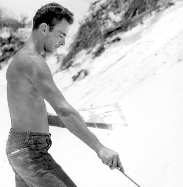 Man hunting for treasure on a beach near Pensacola (1961).