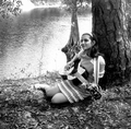 Eugenia Sisinni Jones playing a guitar during the Florida Folk Festival on the grounds of the Stephen Foster Memorial - White Springs, Florida