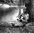 Eugenia Sisinni Jones playing a guitar during the Florida Folk Festival on the grounds of the Stephen Foster Memorial - White Springs, Florida