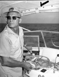 A fisherman looks back while steering the fishing boat during the Shakespeare fishing trip - Panama City, Florida.