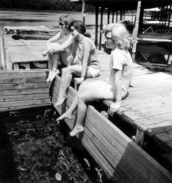 Women sitting above a crab storage bin at Salt springs (circa 1960s).