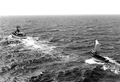 Coast Guard cutter "Cape Strait" with a Haitian refugee boat in tow.