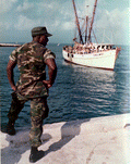 United States Marine looks on as the "Coral Mist" with refugees prepares to dock - Key West, Florida