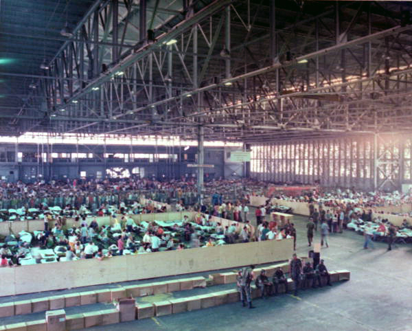 Cuban refugees wait to be processed by U.S. Immigration and Naturalization Service (INS) agents in a temporary housing center located at an old Naval seaplane hangar at Trumbo Point in Key West. About half of the total Cuban entrants of the 1980 Mariel Boatlift were registered at makeshift immigration processing centers in the south Florida cities of Key West, Opa Locka and Miami. 