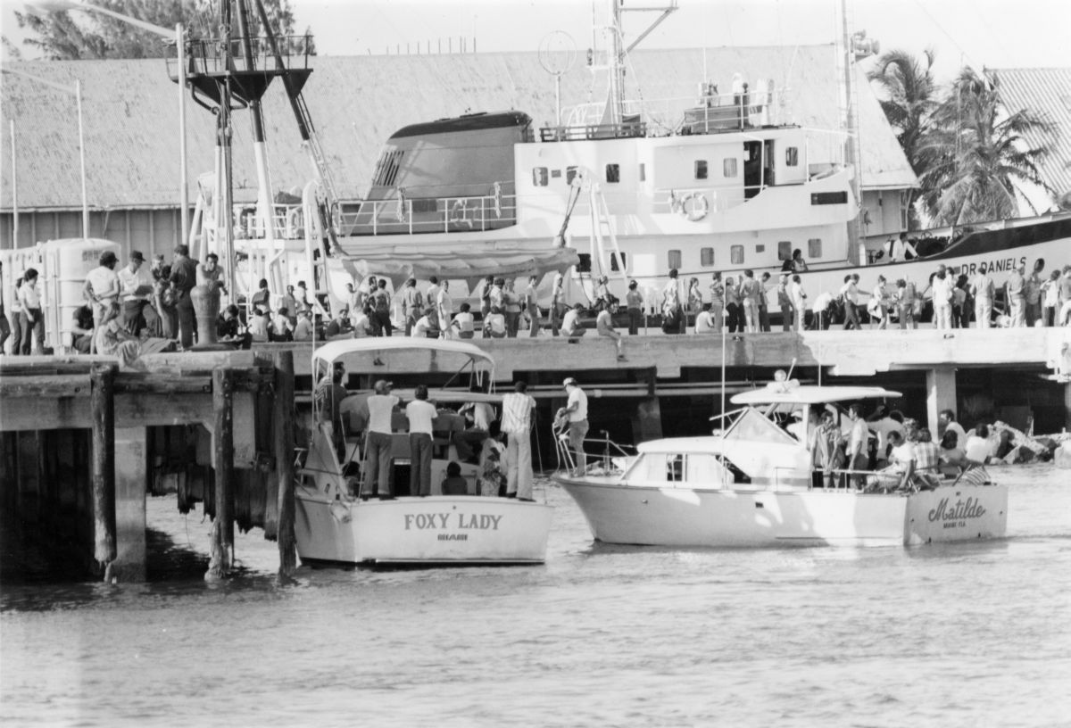 Private vessels “Foxy Lady” and “Matilde” filled with Cuban refugees from Mariel docked at Pier “B” in Key West. After disembarkation, passengers walked from the pier to the makeshift immigration processing center at the Key West Latin Chamber of Commerce. Photograph by Dale McDonald, 1980.