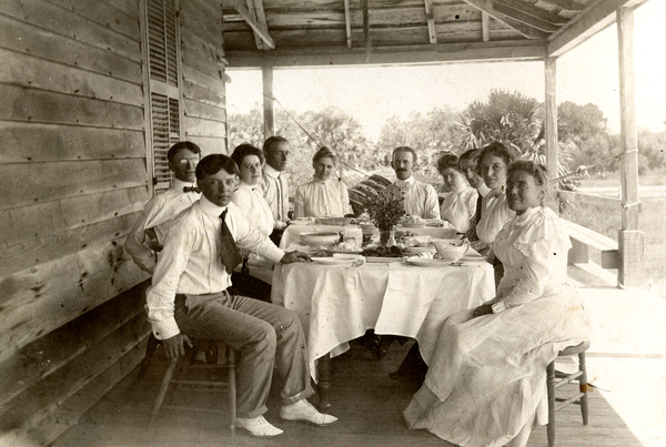 Group of guests having lunch on St. Vincent Island (circa 1910).