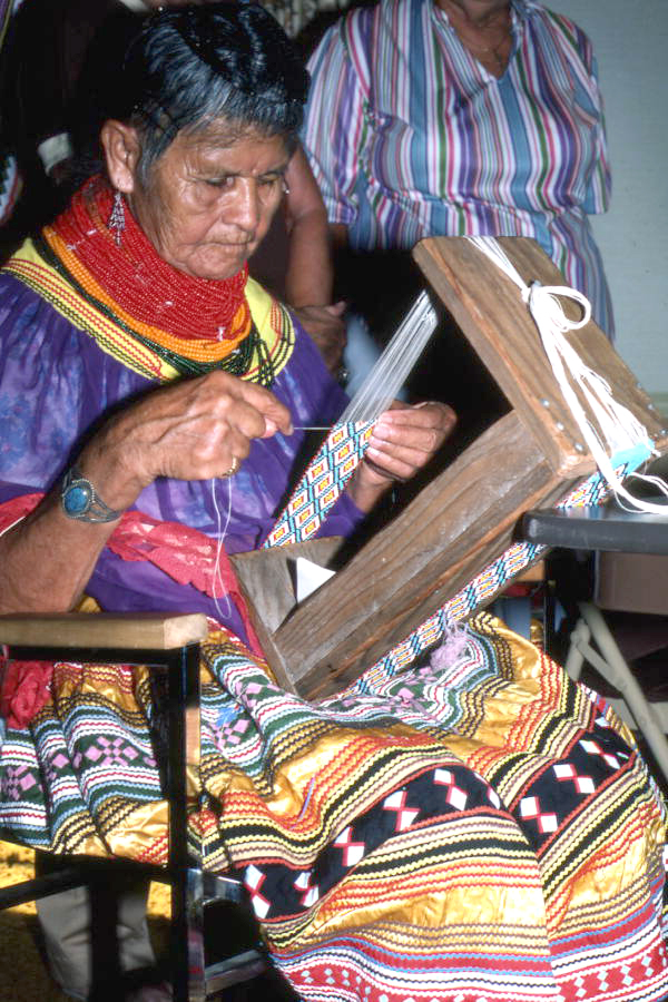 Lottie Shore weaving beads to use on Seminole dolls (1984)