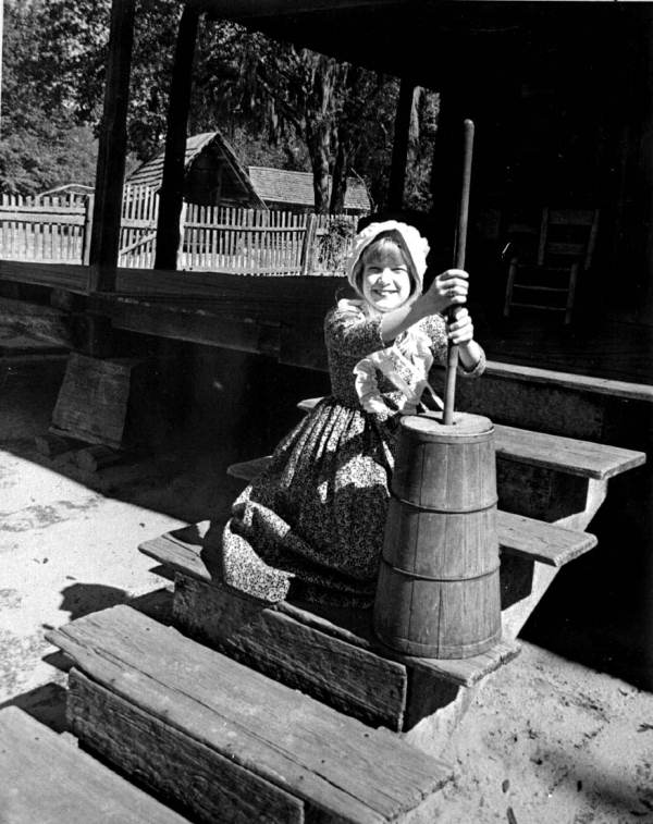 No margarine here! Young Margie Davis is seen here churning butter the old-fashioned way (date unknown).