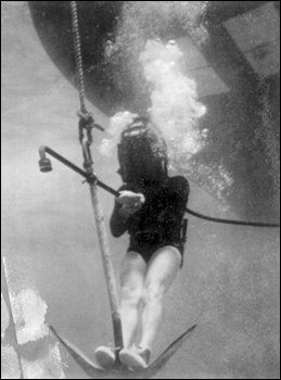 Treasure hunter Art McKee riding the Jolly Roger anchor down to the site of "El Capitana" wreck : Florida Keys, Florida (c. 1960)