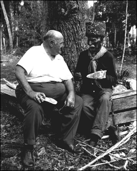 Billy Bowlegs III telling Albert DeVane where he found ancient Indian artifacts while preparing to plant his garden (1962)