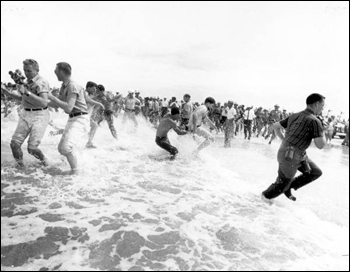 Segregationists trying to prevent blacks from swimming at a "White only" beach (June 25, 1964)