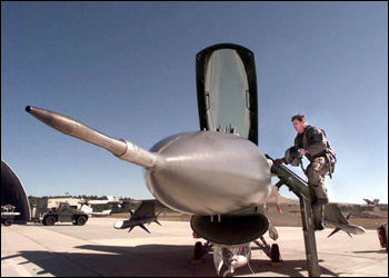 Pilot climbing into an F16 jet fighter airplane at Eglin Air Force Base (2000)