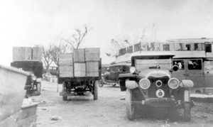 Trucks loaded with coffins, after the hurricane of 1928: Belle Glade (?), Florida