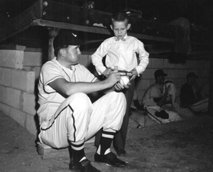 Minor league batting champ Neal Cobb signing baseball for fan: Crestview, Florida (1955)