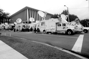 News service trucks in town during the 2000 presidential election vote dispute (2000)