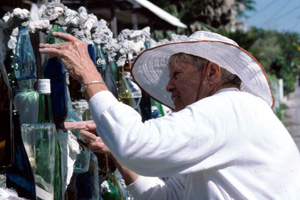 Carolyn Gorton Fuller working on her "bottle wall fence": Key West, Florida (1987)