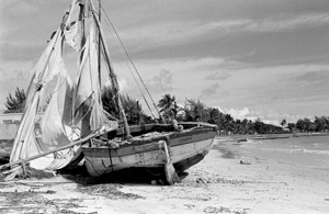 Haitian refugee boat washed up on shore at the Naval Air Station Truman Annex Housing beach (197-)