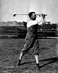 Race car driver Sig Haugdahl with clubs he had specially made: Jacksonville, Florida (1922)