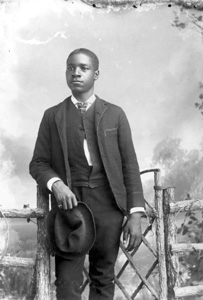 Man holding hat wearing suit