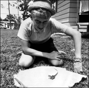 Chip Bloyd in his backyard with baby alligator purchased at Silver Springs: Panama City, Florida (1962)