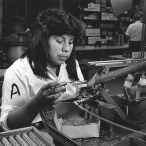 Seminole woman assembling connectors at a factory (1967)