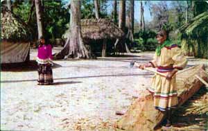 Man making a dugout canoe at the Seminole Village in Silver Springs (1950s)