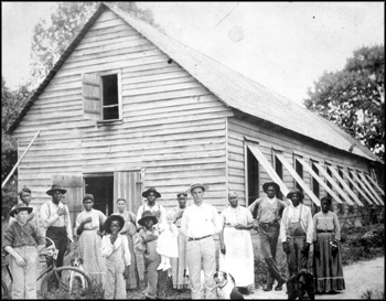 Magnus Delacy Peavy and his farm hands in front of a tobacco barn: Havana, Florida (ca. 1910s)