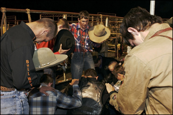 Praying bull riders. Williston Horseman's Park, March 2007.