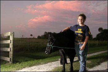 Kaley Dees with cow. Okeechobee, September 2008.