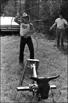 Man practicing for the rodeo roping with a dummy: Macclenny, Florida (1984)