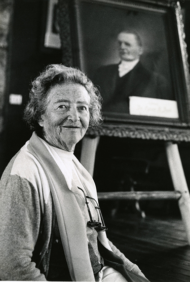 Hedwig Michel with portrait of Cyrus Teed in background