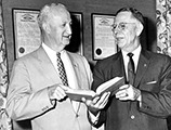 Superintendent of Public Instruction Thomas D. Bailey looking over obsolete textbooks (1961)