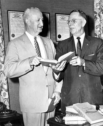 Superintendent of Public Instruction Thomas D. Bailey looking over obsolete textbooks (1961)