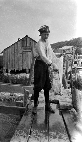 Young man with cast net (ca. 1905)