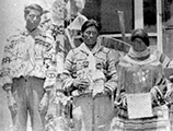 Miccosukee men and women with their crafts outside the mission