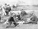 Rough Riders filling belts with cartridges