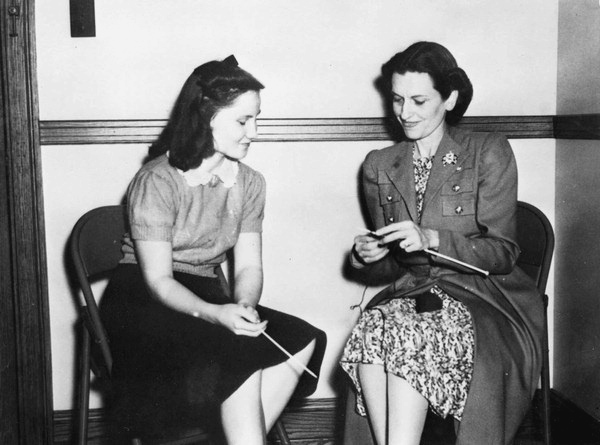 First Lady Mary Holland shows Norma Pennoyer of Coconut Grove how to knit (1941).