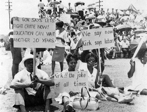 Florida teachers displaying protest signs during their walkout