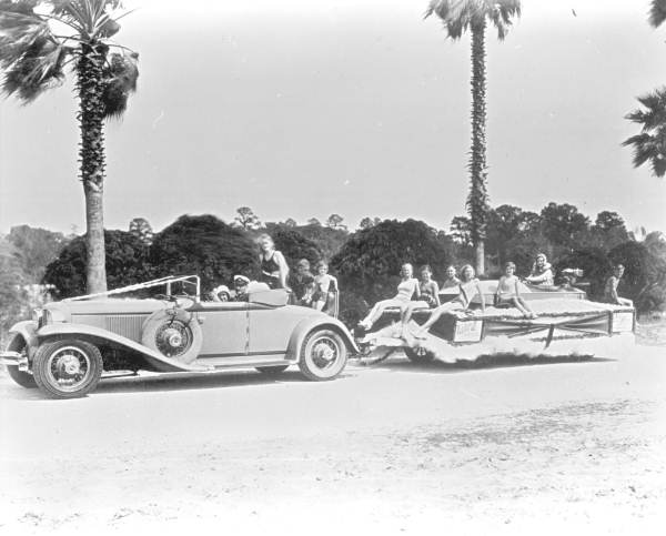 A car pulling a float in the Tung Blossom Festival in Gainesville (circa 1930s).