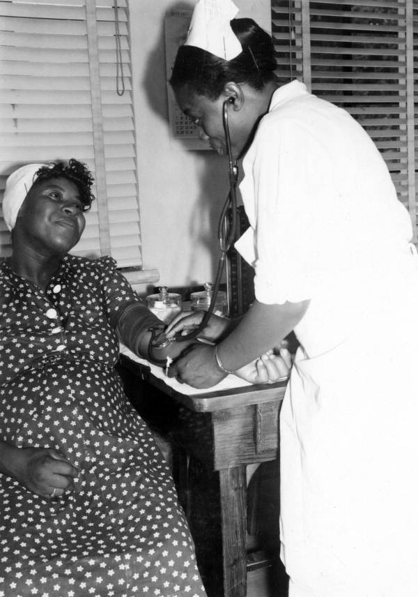 Expectant mother having her blood pressure taken by a registered nurse