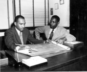 Florida Agricultural and Mechanical College for Negroes president William H. Gray, left, looking over architectural plans.