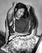 Seminole Indian woman LeTagi (Frances Willie) drapes her hair to side - Miami, Florida.