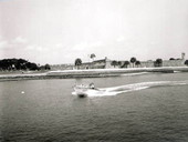 A couple riding on a motorboat running on the bay beside the fort - Saint Augustine, Florida.