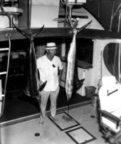 A man proudly poses with his swordfish catch during the Shakespeare fishing trip - Panama City, Florida.