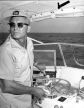 A fisherman looks back while steering the fishing boat during the Shakespeare fishing trip - Panama City, Florida.