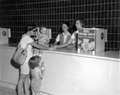 Tourists receive orange juice at the Welcome Station